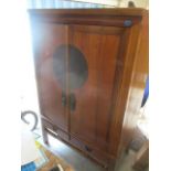 A 20th century Oriental hardwood two door wedding cabinet having twin drawers below, 69 1/2"h x 44"