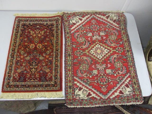 A Persian and a German mat, each with flora and foliage on a red ground, the largest 31" x 22"