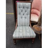 A Victorian nursing chair, mahogany framed front legs with sabre reverse and later upholstery