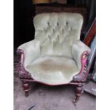 A Victorian mahogany scrolled armchair with deep button back, overstuffed seat, turned vase shaped