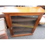 A late Victorian mahogany bookcase, glazed door, fitted with three shelves on a plinth base, 42" h x