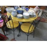 A modern beech and wrought iron kitchen table, 30"h x 36" dia. and a matching set of four chairs