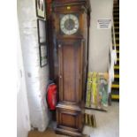 An oak cased early to mid 20th century long cased clock