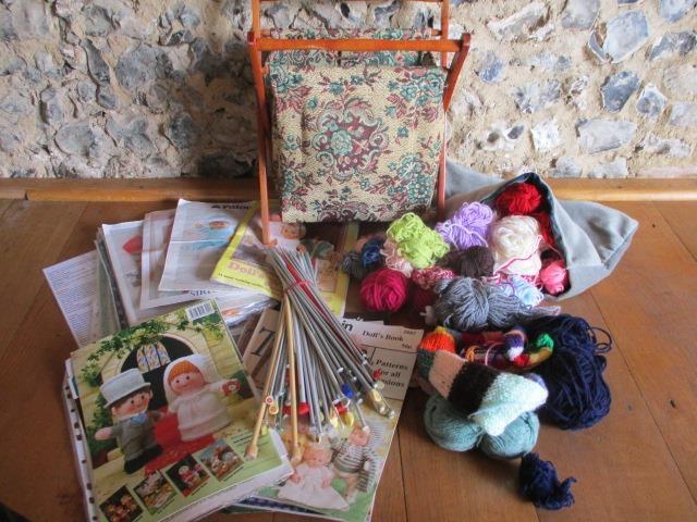 A small quantity of vintage knitting patterns, knitting needles, wool and a sewing basket