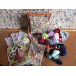 A small quantity of vintage knitting patterns, knitting needles, wool and a sewing basket