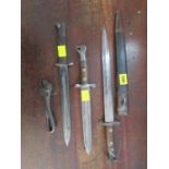 A 1930s British Mole bayonet with steel and leather scabbard, a Victorian bayonet and one other,