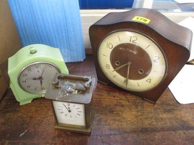 A group of three clocks to include a Bakelite mantel clock, a mahogany framed clock and a carriage