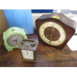 A group of three clocks to include a Bakelite mantel clock, a mahogany framed clock and a carriage