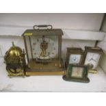 Four clocks to include a Cyma Amic, Mappin and Webb carriage clock