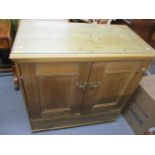 A Victorian and later pine cabinet having two cupboard doors and single drawers below, 38" h x 38" w