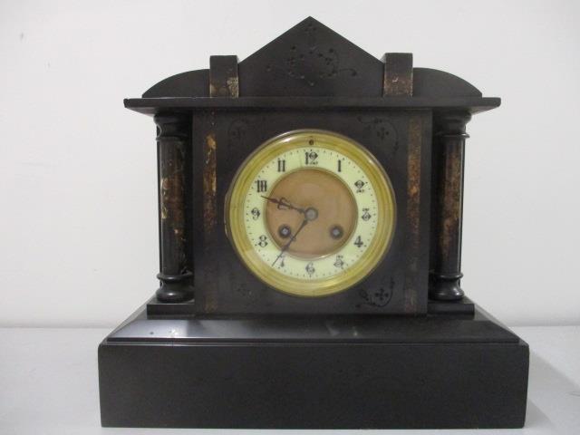 A Victorian black marble mantle clock of architectural form, with bell strike movement, 11" h