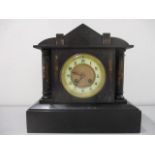 A Victorian black marble mantle clock of architectural form, with bell strike movement, 11" h