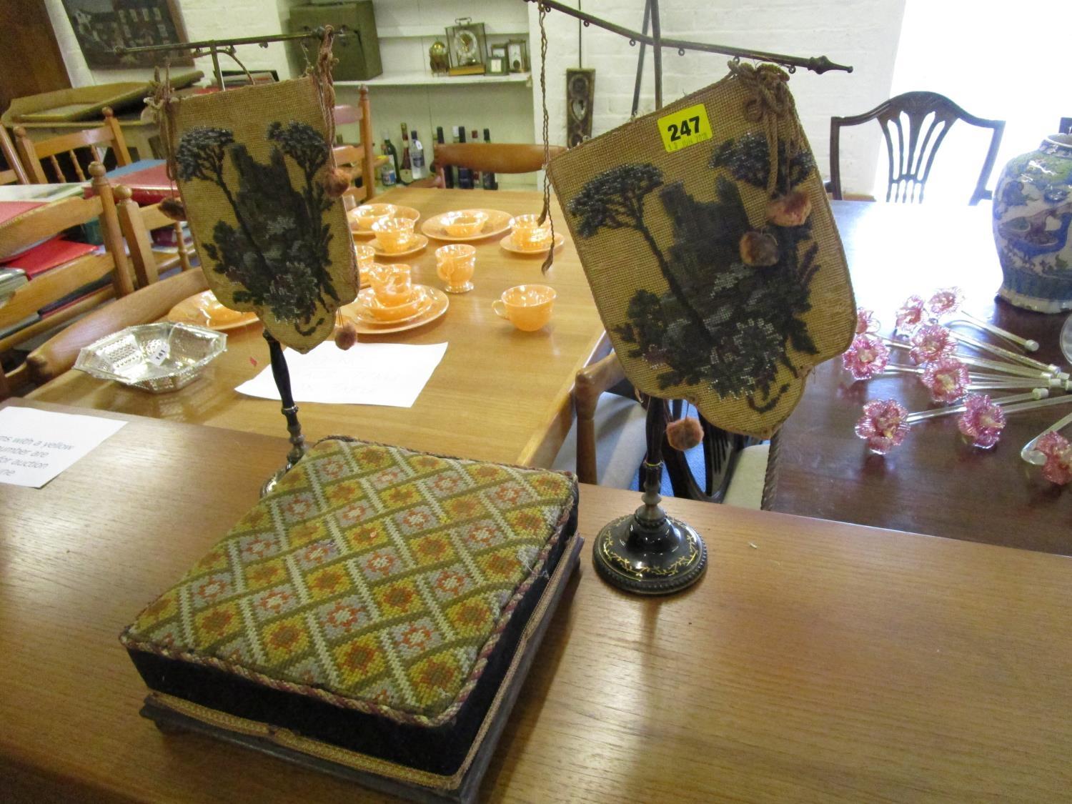 A pair of Victorian black glazed, ceramic and gilt glass table face screens, each with a beaded