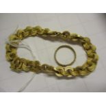 A yellow metal loop bracelet and a matching ring