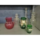 Victorian glassware to include a Cranberry glass jug and cut and etched decanters