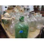 A large quantity of glass demi Johns