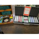 A cased games box containing a mini roulette wheel, dominoes and various counters, along with a case