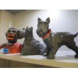 A reproduction money-box together with two metal models of Scotty dogs