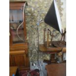 A pair of Italian flexible standard lamps and a chrome standard lamp with a large black shade,