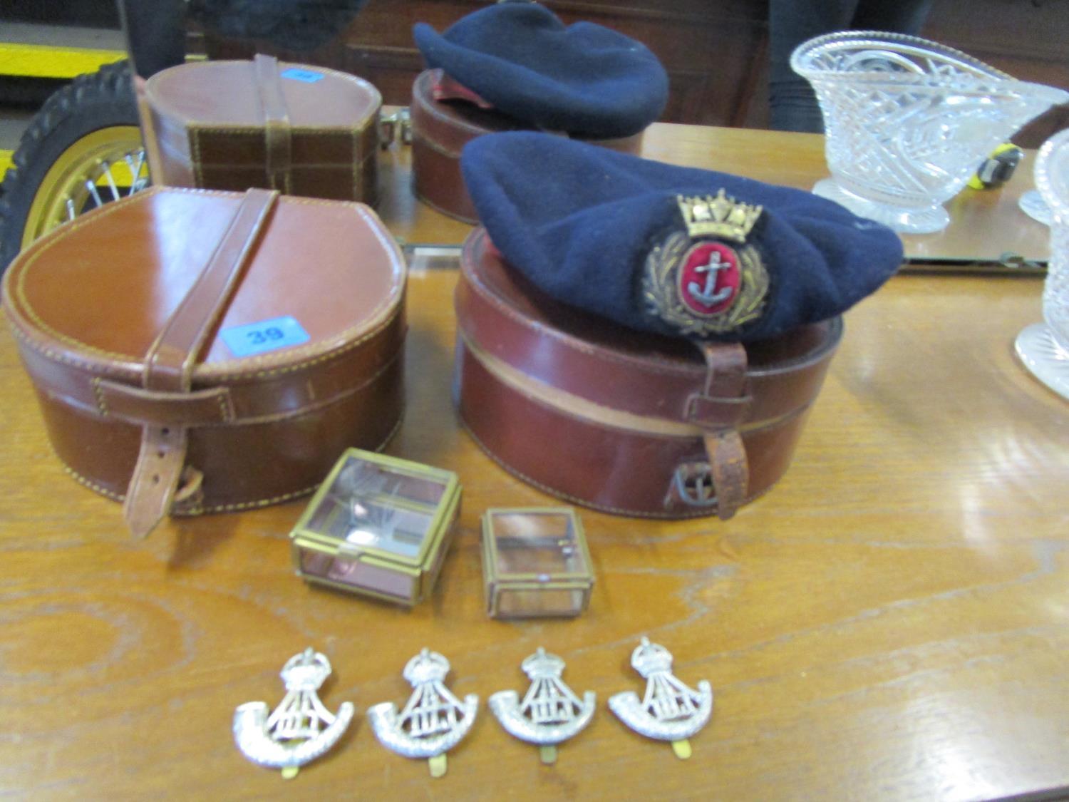 Durham Light Infantry cap badges, an early 20th century navy cap with a gold button badge and two
