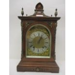 An early 20th century eight day striking clock. The mahogany case has four brass cone finials