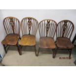 A matched set of four 18th/19th century fruitwood, ash and elm Windsor chairs, each having a