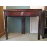 A George III mahogany tea table having a foldover top, over a frieze drawer, raised on square,