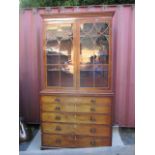 A George II mahogany bookcase cabinet, having moulded cornice over twin glazed doors, above a