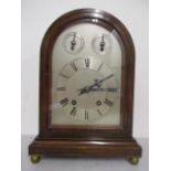 An early 20th century mahogany, arched topped cased mantle clock by Winterhalder & Hoffmeier, having