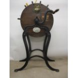A Victorian Kent's oak cased knife cleaner on a cast iron stand with splayed legs, 42" h