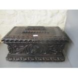 A late 19th century carved oak casket having a hinged lid over straight sides and plinth,