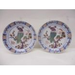 A pair o mid 18th century Dutch Delft dishes, decorated in polychrome enamels, with bird perched