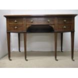 A Victorian mahogany and marquetry desk having a drawer flanked by four drawers, with scrolled