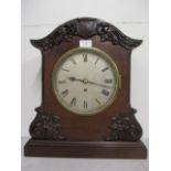 A Victorian mahogany bracket clock having an 8" silver dial with Roman numerals, contained in a