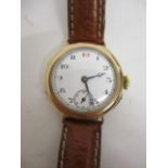 An early 20th century 9ct gold cased trench watch, having a white enamelled dial, Arabic numerals,