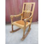 A Robert Thompson Mouseman oak rocking chair with a carved, woven effect back, curved arms and brown