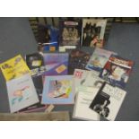 A collection of concert programs and their respective entry tickets to include 1985 Dire Straits,