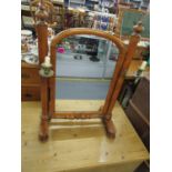 A Victorian mahogany swing mirror with arched glass plate, flanked by horns with turned finials