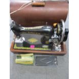 A 1947 Singer sewing machine in an oak case, serial number ED947397