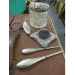 A mixed lot to include a silver topped vanity pot, ornate silver pin cushion and silver pedicure