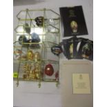 A collection of reproduction ornamental eggs with glass display stand and 'Collectors Treasury of
