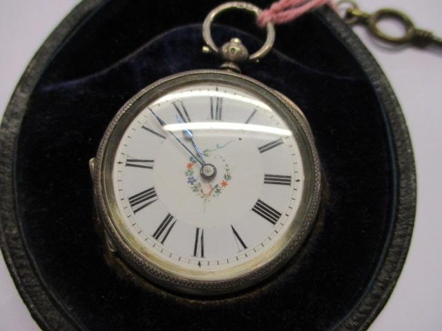 A 19th century silver pocket watch with an enamelled face and floral design, cased - Image 4 of 4