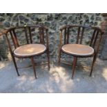 A pair of Edwardian inlaid mahogany chairs with upholstered seats