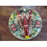 A Portuguese Pallisy charger decorated with a lobster and seashells, 13" dia