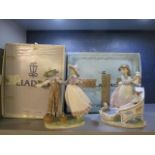 Two Lladro porcelain figures to include a woman with flowers and a scarecrow, model no 5.385, boxed
