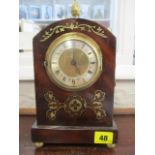 A 19th century and later small mahogany and brass inlaid mantle clock, having acorn finial and