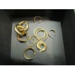 A group of 9ct gold and yellow metal hoop earrings, total weight 14g