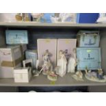 A selection of Lladro porcelain figurines to include a seated girl with a puppy, boxed