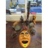 A selection of carved wooden ornaments and a stone Zimbabwean fruit serpentine carved stone face