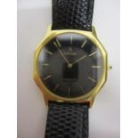 A Concorde gents quartz 18ct gold wristwatch having a black dial, gilt baton markers in an